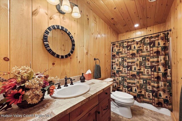 bathroom with wood walls, wooden ceiling, and toilet