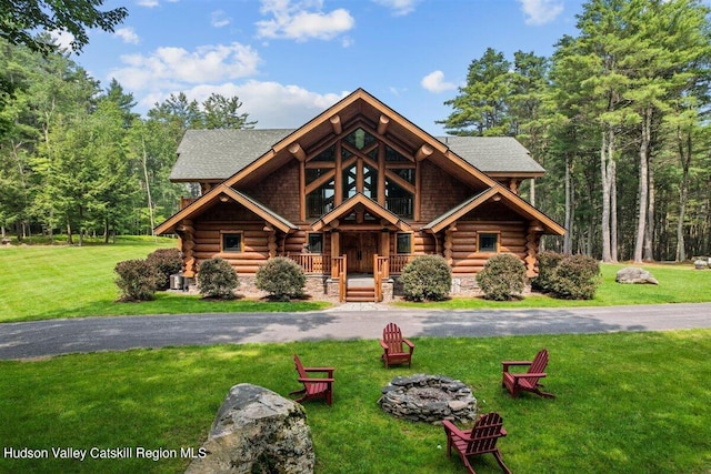 log cabin featuring a front yard and covered porch