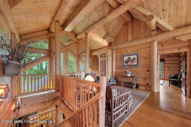 interior space featuring hardwood / wood-style flooring, beam ceiling, wooden ceiling, and high vaulted ceiling