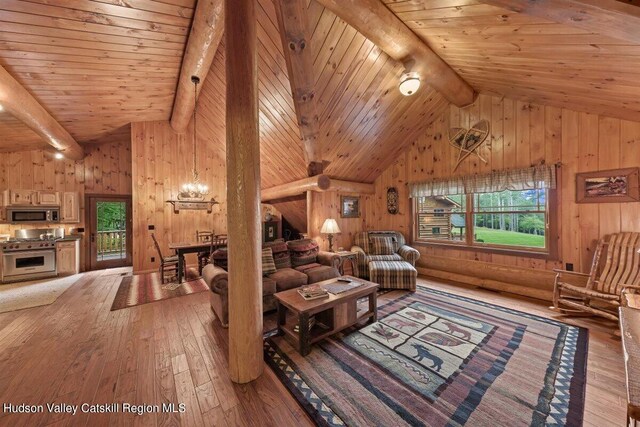 living room with beam ceiling, plenty of natural light, high vaulted ceiling, and wood-type flooring