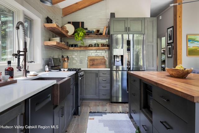 46 Rose Ln, Woodstock, NY 12409 - kitchen with appliances with stainless steel finishes, open shelves, wood counters, and vaulted ceiling