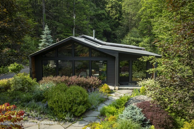 46 Rose Ln, Woodstock, NY 12409 - rear view of house featuring a view of trees