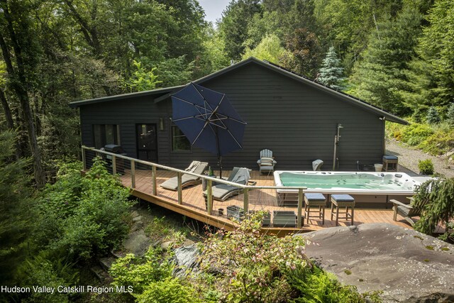 46 Rose Ln, Woodstock, NY 12409 - rear view of house featuring a deck and a wooded view