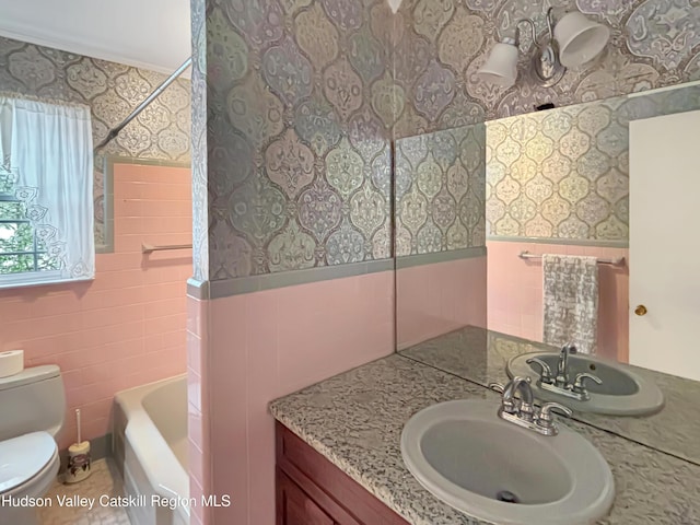 full bathroom featuring a wainscoted wall, toilet, tile walls, and wallpapered walls