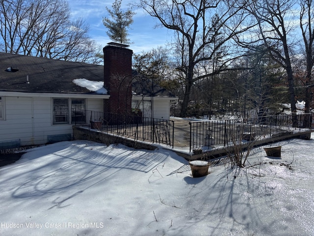 snow covered deck with fence