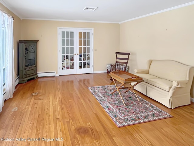 living area featuring french doors, crown molding, visible vents, a baseboard heating unit, and wood finished floors