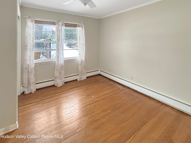 unfurnished room featuring a baseboard heating unit, a ceiling fan, ornamental molding, and wood finished floors