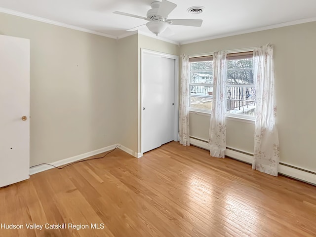 unfurnished bedroom with baseboards, ornamental molding, visible vents, and light wood-style floors