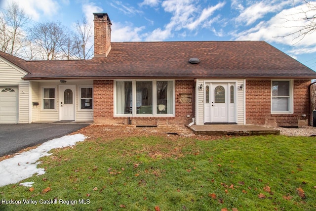 single story home with a garage and a front yard