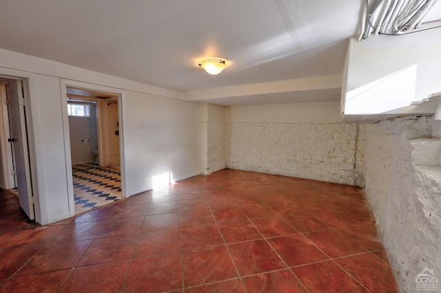 below grade area featuring dark tile patterned floors