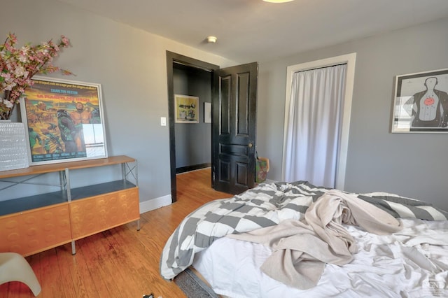 bedroom featuring wood finished floors and baseboards