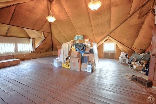 bonus room featuring lofted ceiling, wood-type flooring, wooden ceiling, and wooden walls