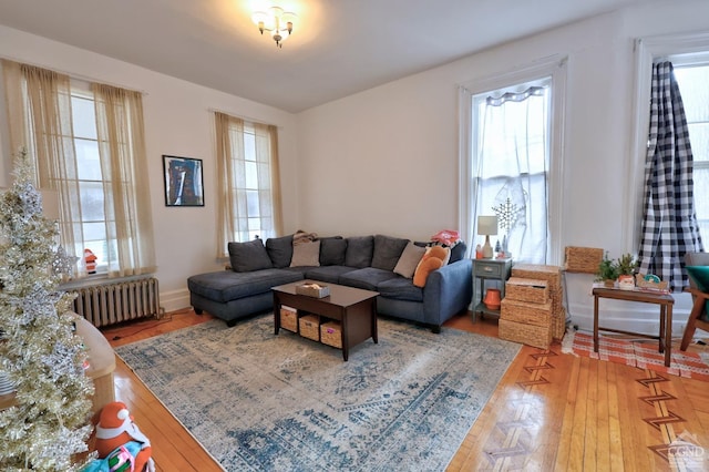 living area with radiator heating unit and healthy amount of natural light