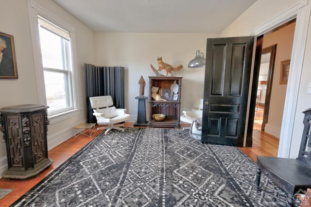 living area with wood finished floors and baseboards
