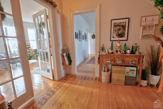 corridor with wood-type flooring and baseboards