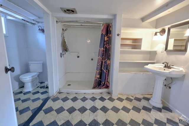 bathroom with tile patterned floors, toilet, and a stall shower