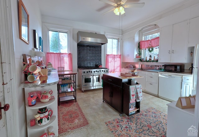 kitchen featuring ventilation hood, white dishwasher, double oven range, black microwave, and white cabinets