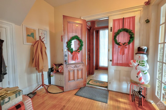 foyer entrance featuring healthy amount of natural light, light wood-style floors, and baseboards