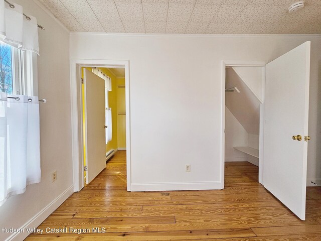 interior space featuring wood-type flooring and baseboard heating