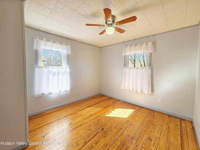 unfurnished room featuring ceiling fan and wood-type flooring