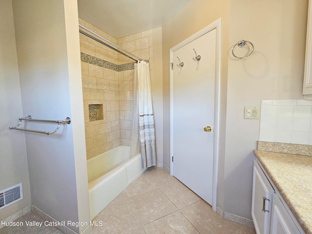 bathroom featuring tile patterned flooring, vanity, and shower / bathtub combination with curtain