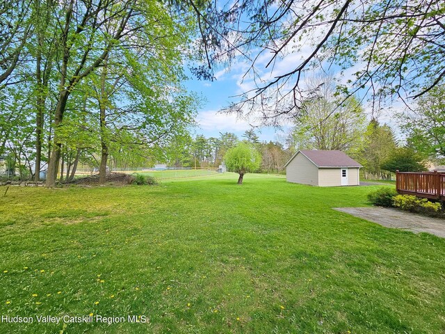 view of yard with an outbuilding and a deck