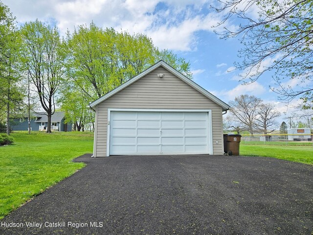 garage featuring a lawn