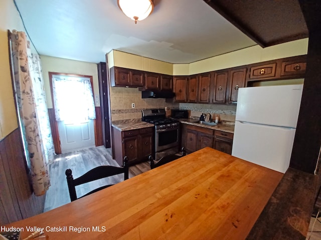 14 Center Rd, High Falls, NY 12440 - kitchen featuring freestanding refrigerator, stainless steel gas range oven, extractor fan, dark brown cabinets, and backsplash