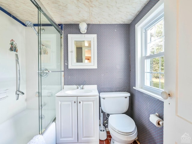161 Beaver Hill Rd, Gilboa, NY 12076 - bathroom featuring plenty of natural light, toilet, wallpapered walls, vanity, and combined bath / shower with glass door
