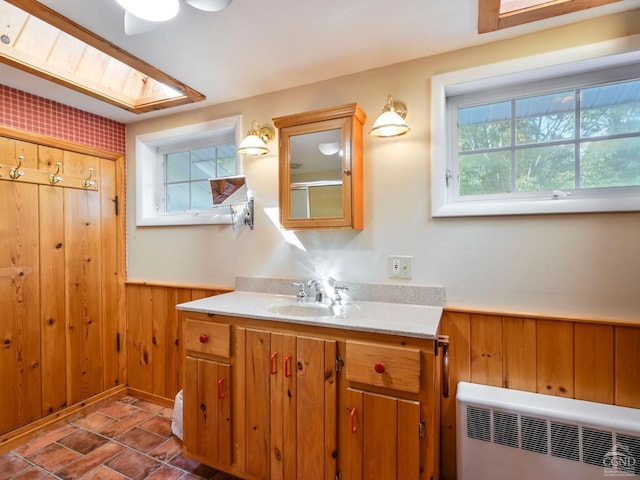 161 Beaver Hill Rd, Gilboa, NY 12076 - bathroom featuring wainscoting, wood walls, vanity, and radiator