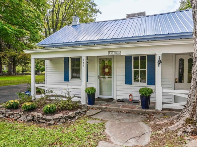 161 Beaver Hill Rd, Gilboa, NY 12076 - view of front facade featuring a porch, metal roof, and a chimney