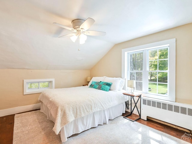 161 Beaver Hill Rd, Gilboa, NY 12076 - bedroom featuring radiator, vaulted ceiling, wood finished floors, ceiling fan, and baseboards