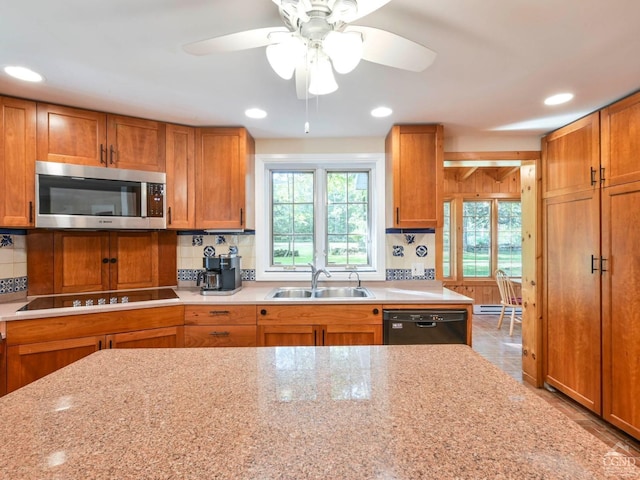 161 Beaver Hill Rd, Gilboa, NY 12076 - kitchen with black appliances, a sink, backsplash, brown cabinetry, and recessed lighting