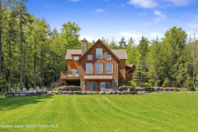 16 High W Rd, Windham, NY 12496 - rear view of property featuring stairs, a chimney, a wooden deck, a lawn, and stone siding
