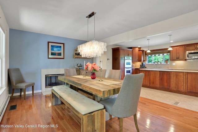 14 Glenerie Ln, Saugerties, NY 12477 - dining area featuring light wood-style flooring and a chandelier