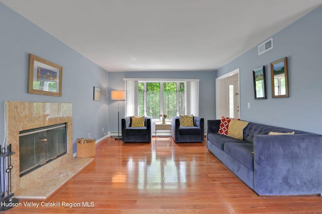 14 Glenerie Ln, Saugerties, NY 12477 - living room with wood finished floors, a fireplace, and a baseboard radiator