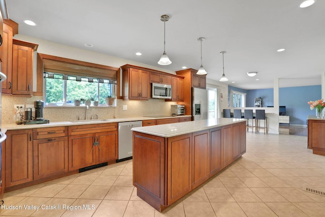 14 Glenerie Ln, Saugerties, NY 12477 - kitchen with appliances with stainless steel finishes, decorative backsplash, brown cabinetry, and recessed lighting
