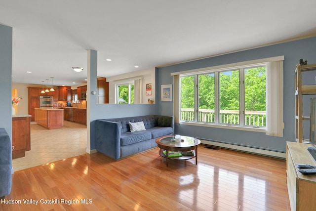 14 Glenerie Ln, Saugerties, NY 12477 - living area with baseboard heating, light wood finished floors, and recessed lighting
