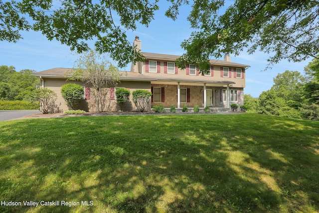 14 Glenerie Ln, Saugerties, NY 12477 - traditional-style home featuring a chimney, a front lawn, and a porch