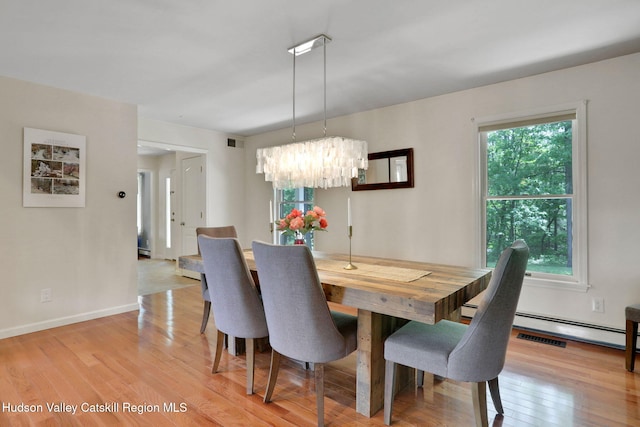 14 Glenerie Ln, Saugerties, NY 12477 - dining room with healthy amount of natural light, a chandelier, light wood-type flooring, and a baseboard radiator
