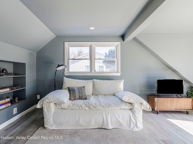 bedroom with lofted ceiling, wood finished floors, and baseboards