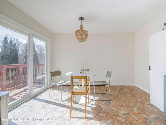 dining area featuring baseboards