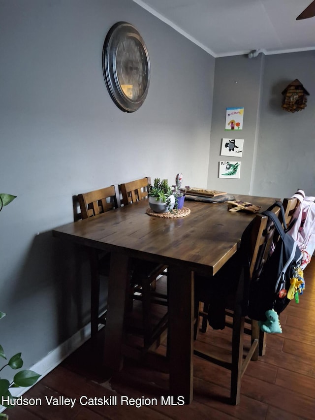 dining room with ornamental molding and wood finished floors