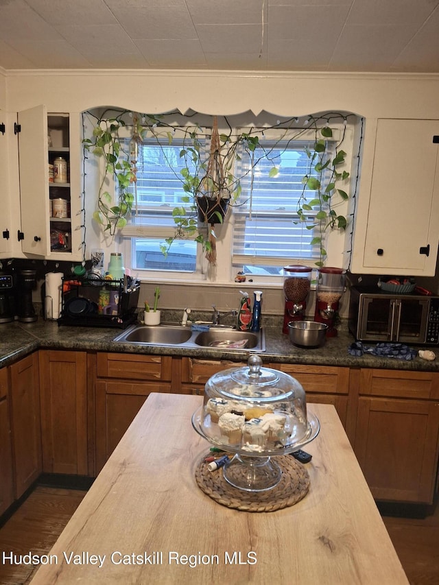 kitchen with plenty of natural light, brown cabinets, and a sink