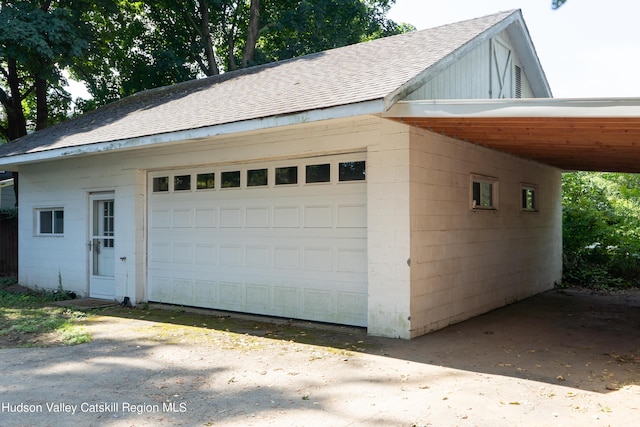 garage featuring a carport