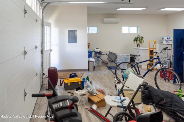 garage featuring a wall mounted air conditioner and electric panel