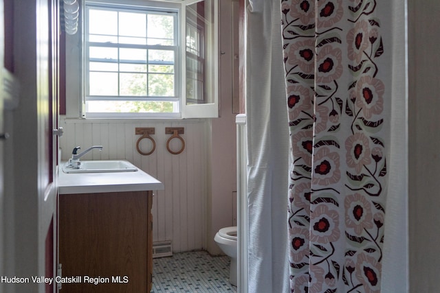 bathroom featuring tile patterned floors, a shower with curtain, vanity, wooden walls, and toilet