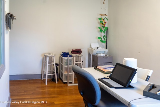 home office with dark hardwood / wood-style flooring