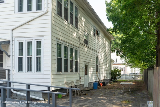 view of side of home featuring central AC and a patio