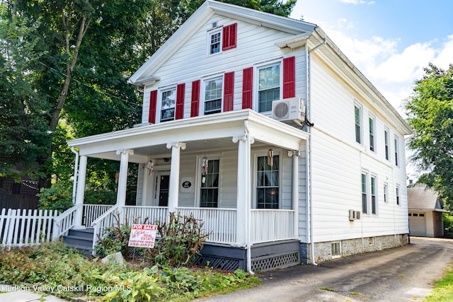 view of front of house with covered porch and ac unit